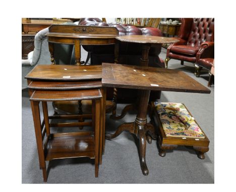 A nest of three stained walnut occasional tables, each with a bowfront, width 46cm and smaller; and oak pedestal table; a car