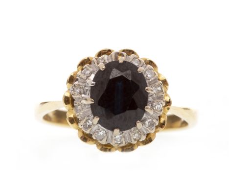 BLUE GEM AND DIAMOND CLUSTER RINGset with a central oval blue gem 8mm long and within a diamond halo, in turn within a pierce