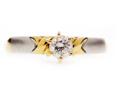 DIAMOND SOLITAIRE RINGwith a six claw mounted round brilliant cut diamond of approximately 0.21 carats set high to a bi colou