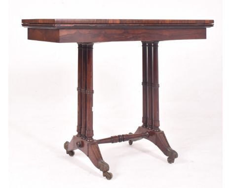 A 19th century Victorian rosewood card / games table. The table having a fold over swivel top lined with green felt to the in