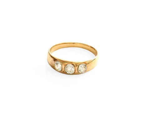 A Late Victorian Diamond Three Stone Ring, the old cut diamonds inset within a yellow plain polished band, finger size N1/2Th