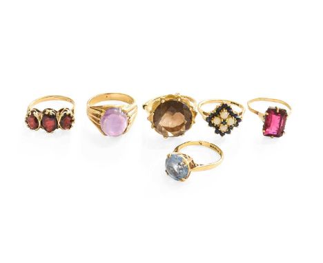 Six Dress Rings, comprising of a cabochon amethyst ring, stamped '9CT', finger size L; a 9 carat gold smoky quartz ring, fing