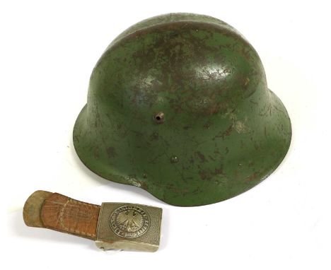 A Bulgarian M36 Type C Combat Helmet, with green paint and remnants of shield decal, the leather liner stencilled 56 and atta