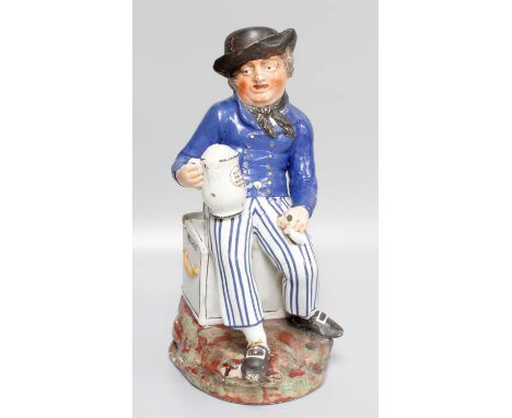 An Early 19th Century Enamel Painted ''Amercan Sailor'' Toby Jug, holding a tankard, inscribed ''Success to our Wooden Walls'