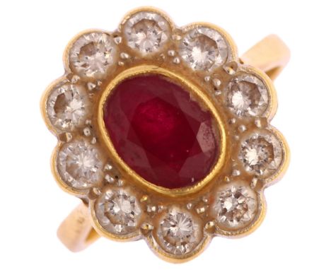 An 18ct gold ruby and diamond oval cluster ring, set with oval mixed-cut ruby and modern round brilliant-cut diamonds, total 