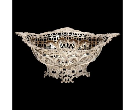 A Victorian silver table centre fruit bowl of oval form, floral embossed surround with shaped and pierced sides, London 1894,