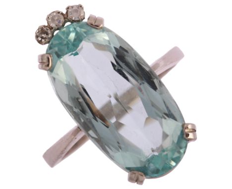 A modern 18ct white gold aquamarine and diamond dress ring, set with long oval mixed-cut aquamarine and single-cut diamonds, 