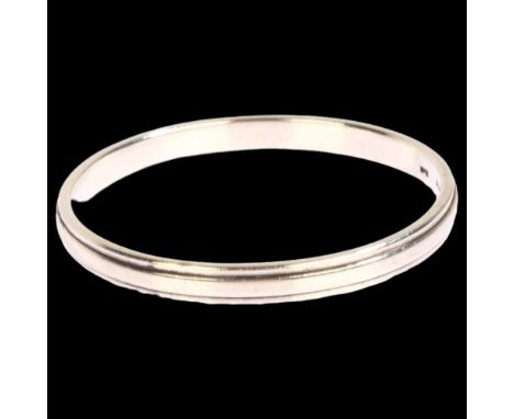 HANS HANSEN - a sterling silver plain form circular bangle, internal diameter 64mm, 37gLight surface scratching through norma