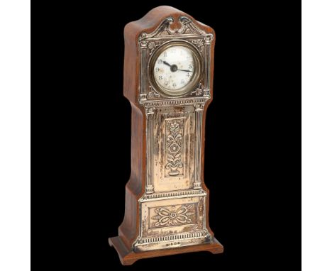 A silver-fronted mantel clock in the form of a longcase clock, with embossed mounts and enamel dial, Birmingham 1908, height 