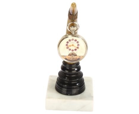 An early 20th century nickel open-face keyless pocket watch, by Hebdomas, white enamel dial with hand painted purple enamel R