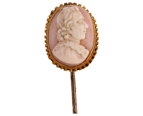 A Victorian pink coral cameo stickpin, circa 1860, relief carved depicting male profile, in unmarked yellow metal frame, head