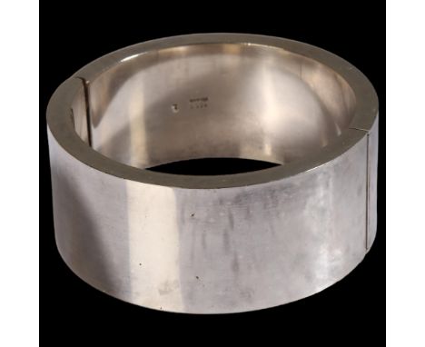 A heavy Danish sterling silver plain form hinged bangle, no maker's mark, band width 25.7mm, internal circumference 16cm, 67.