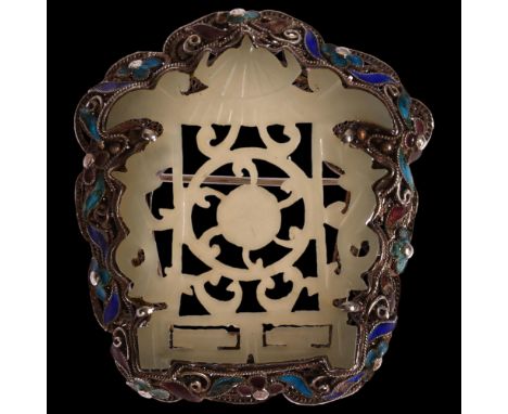 A Chinese carved and pierced jade brooch in silver filigree and enamel shaped setting, 50 x 45mm, 19gSeveral tiny pieces of e