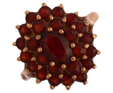 A late 20th century 9ct gold garnet oval cluster ring, set with oval mixed and round-cut garnets, setting height 17.1mm, size