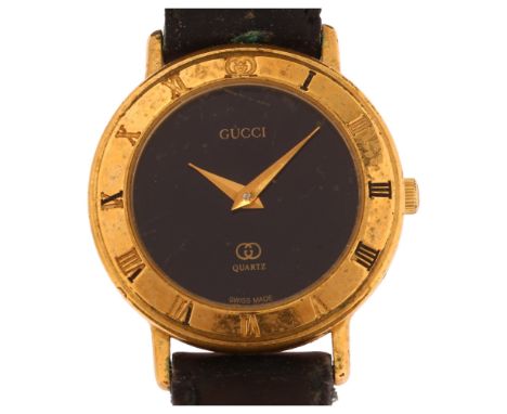 GUCCI - a lady's gold plated 3001L quartz wristwatch, circa 1986, black dial with Roman numeral bezel, case no. 130-116, case