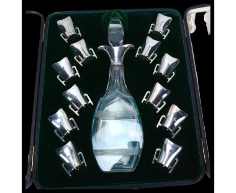 An Edwardian silver-mounted decanter and Mether cup liqueur set, the square cut-glass decanter having double-lipped spout, He
