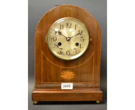 An inlaid veneered mantle clock,with pendulum and key.