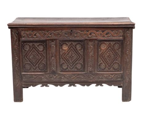 A Charles II oak coffer, circa 1670,: with hinged cover above a relief carved frieze of Viruvian scrolled fruiting grape vine