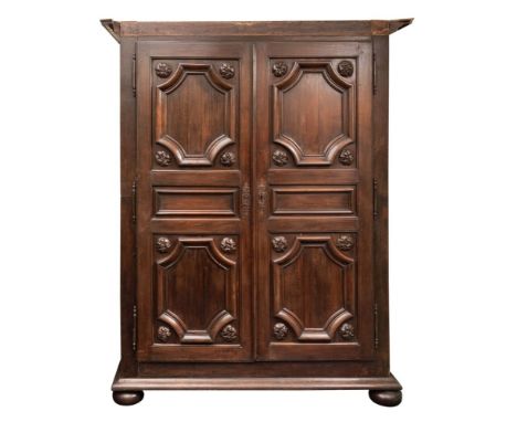A Flemish oak armoire, 18th century; with dentil moulded cornice above two doors with panel mouldings, the sides also panelle