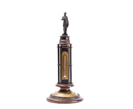 A Victorian simulated rosewood "Prince Albert Memorial" desk top thermometer surmounted by a bronzed metal figure of Prince A