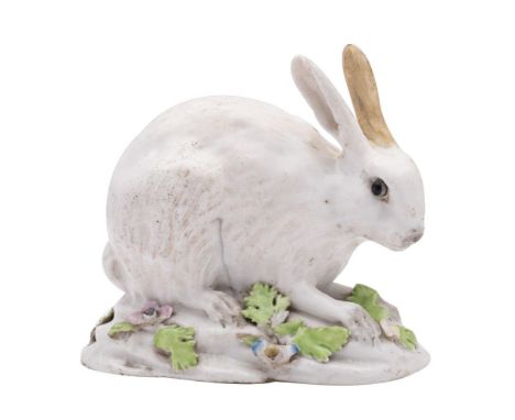 A Continental figure of a leveret in the Meissen manner after J.J.Kaendler, modelled crouching and on mound base applied with