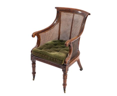 A Regency mahogany and canework library bergere, circa 1815; the frame with old black linear paint overall to simulate rosewo