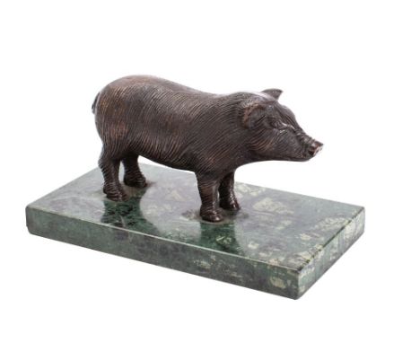 A bronze model of a pig mounted on a polished variegated green marble base, unsigned 17.5cm long. 