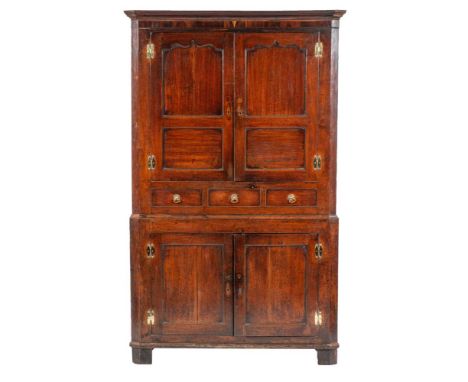 A George II corner cupboard, mid 18th century, with moulded cornice above twin panel shallow Gothic arched doors; above three