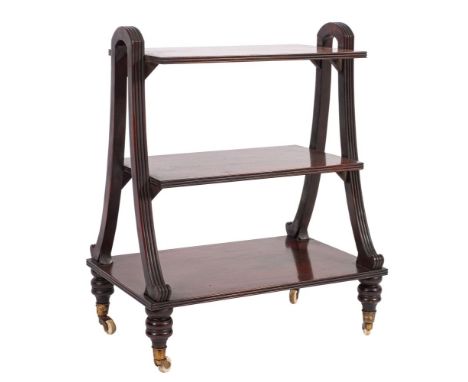 A mahogany library porter in Regency style, 20th century; the three rectangular shelves with reeded edges, held in twin openw