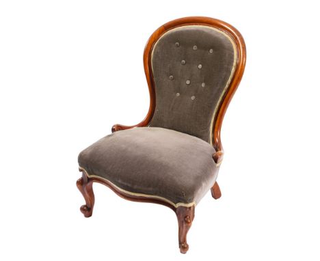 A Victorian walnut and velvet button upholstered nursing chair, circa 1870; the backrest with show frame, above cabriole fron