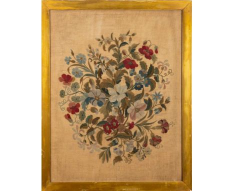 A 19th century needlework panel depicting a floral spray, worked in coloured silks of reds, greens, browns and blues, framed 