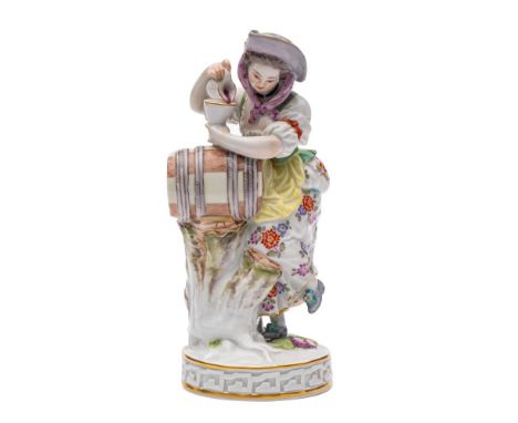 A Meissen figure of a girl vintner modelled after the original by  Michael Victor Acier wearing a floral decorated skirt and 