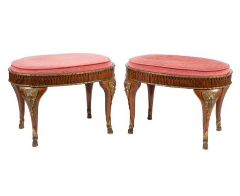 A pair of walnut and gilt bronze mounted oval stools in Louis XVI taste, 20th century; the upholstered drop in seats held in 