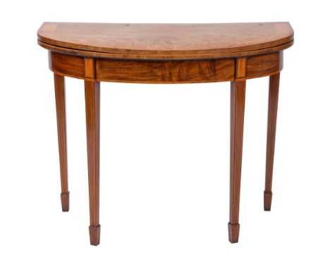 A George III mahogany, crossbanded and line inlaid D-shaped card table, late 18th century; the hinged top opening to an inter