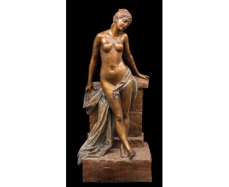 A large Goldscheider Art Nouveau bronzed earthenware figure in the form of a semi-naked girl leaning against a wall, impresse
