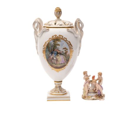 A Meissen pot pourri and cover and a small mythological group of four cherubs the vase with entwined serpent handles and bud 