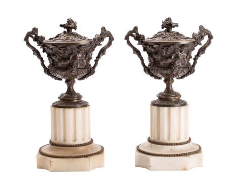 A pair of 19th century bronze vases and covers of urn-shaped outline, the domed lift-off covers with grape and vine leaf deco