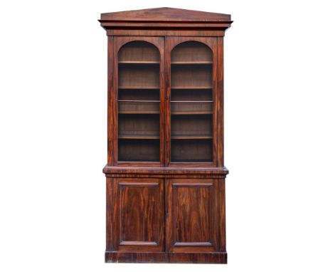 A Victorian mahogany and glazed cabinet bookcase, circa 1870; with pediment above a stepped and ogee moulded cornice, above t