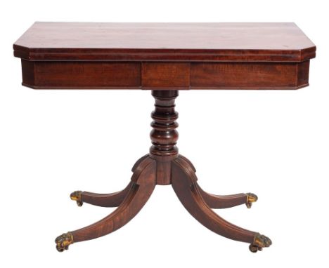 A Regency mahogany card table, circa 1815; the hinged rectangular top with canted front corners; the plain friezes with a pro