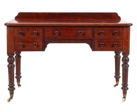 A Victorian mahogany dressing table, mid 19th century; the top with back gallery, rounded front corners and ovolo moulded edg