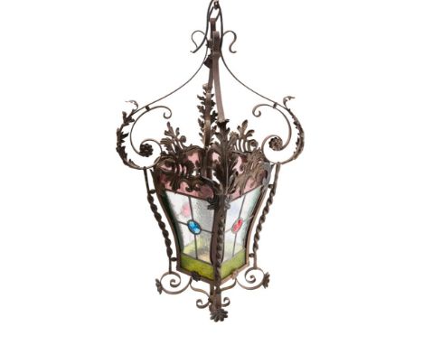 A Victorian wrought iron and glazed hanging lantern of square waisted and tapering form, with leaded glass panels on foliate 