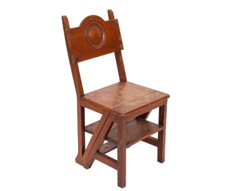 A Victorian mahogany library step chair, late 19th century; the panel backrest with arched top above a recessed roundel; hing