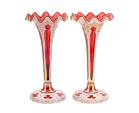 A pair of Bohemian ruby and white overlay glass lustre stands with frilled rims, gilded with scrolling foliage, late 19th cen