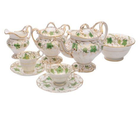 An H & R Daniel porcelain part tea service of moulded rococo form  enamelled with green vines amongst  gilt foliage and scrol