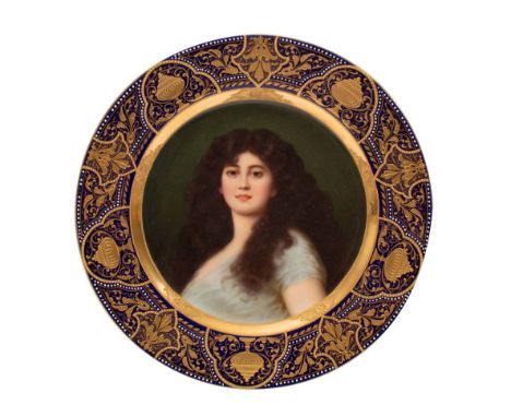 A Vienna cabinet plate painted with a head and shoulders portrait of a female beauty within an elaborate gilt and jewelled co