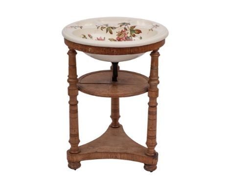 A Victorian glazed ceramic and mahogany mounted washstand, last quarter 19th century; the circular top stamped for Brown-West