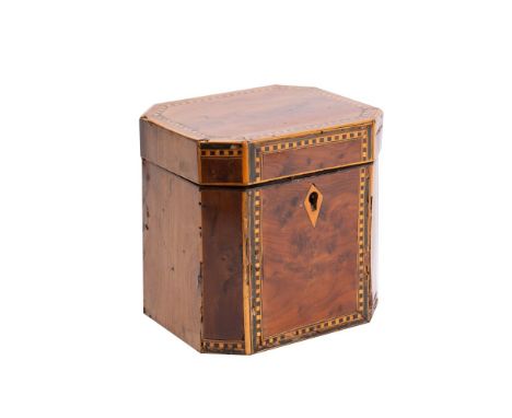 An 18th century yew wood and chequer inlaid tea caddy of rectangular outline with canted corners, the hinged lid enclosing a 