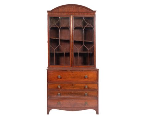 A Regency mahogany and line inlaid secretaire bookcase, circa 1815,: with moulded arch pediment above twin glazed doors with 