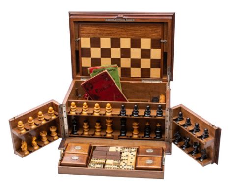 An early 20th century mahogany games compendium  fitted with folding games board, boxwood and ebony chess set, counters for d