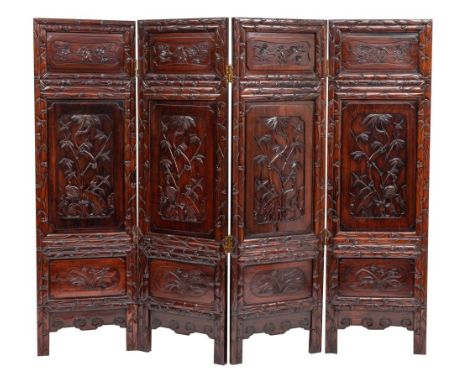 A Chinese carved hardwood, probably huanghuali double sided four leaf room screen, 19th century; each leaf with a central pan